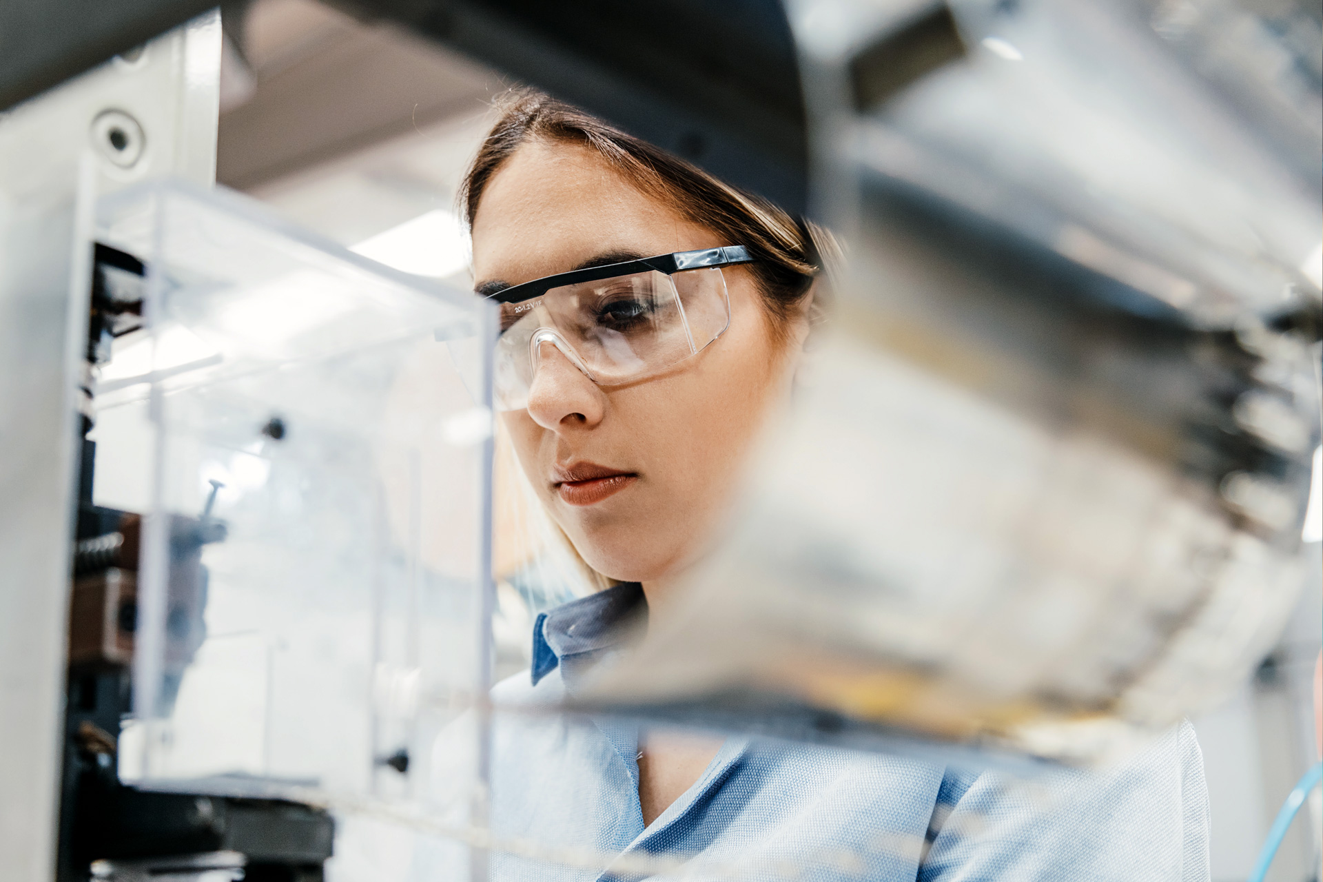 Woman wearing safety glasses working in a laboratory