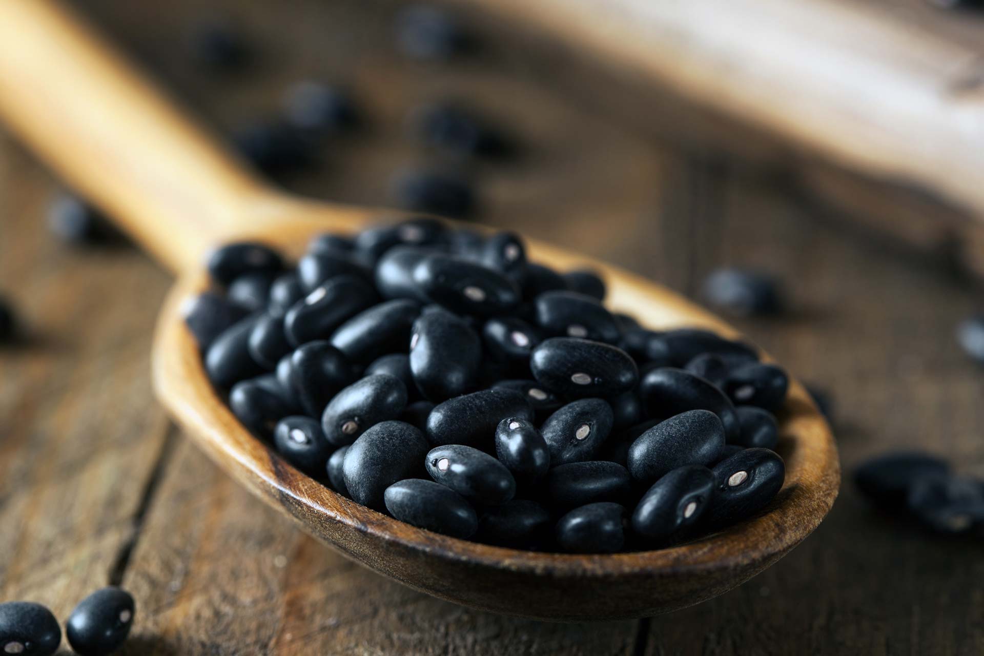 black beans in a wooden spoon